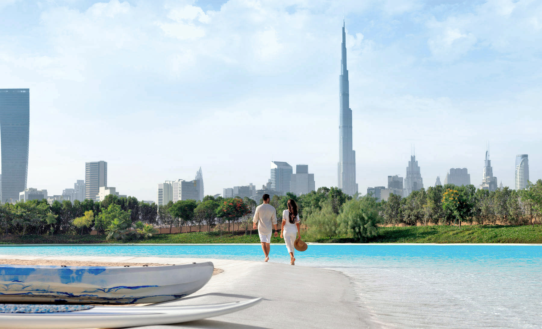 A couple walk by a pure turquoise lagoon powered by Crystal Lagoons technology