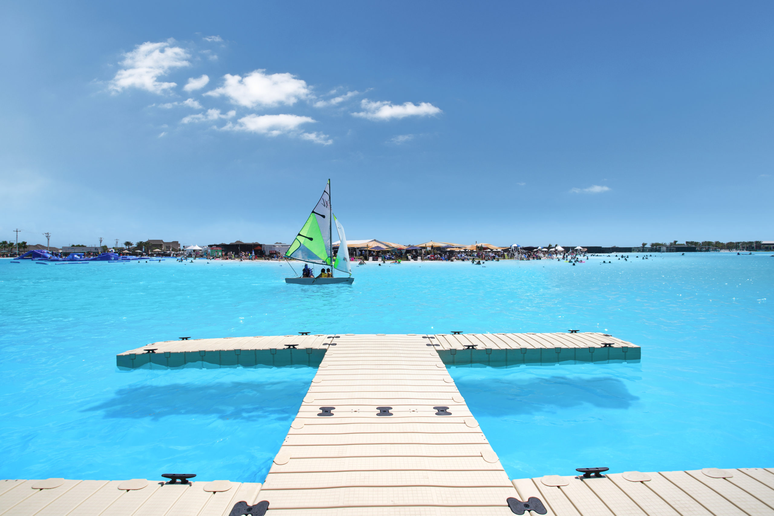 A large crystalline lagoon by CRystal Lagoons with a windsurf
