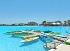 Bright kayaks floating on aman-made turquoise lagoon by Crystal Lagoons