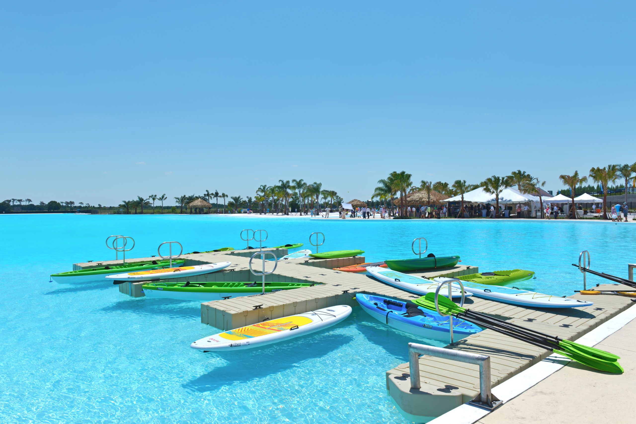 Bright kayaks floating on aman-made turquoise lagoon by Crystal Lagoons