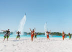 Windsong Ranch Lagoons in Texas. People dancing on the white sand beach