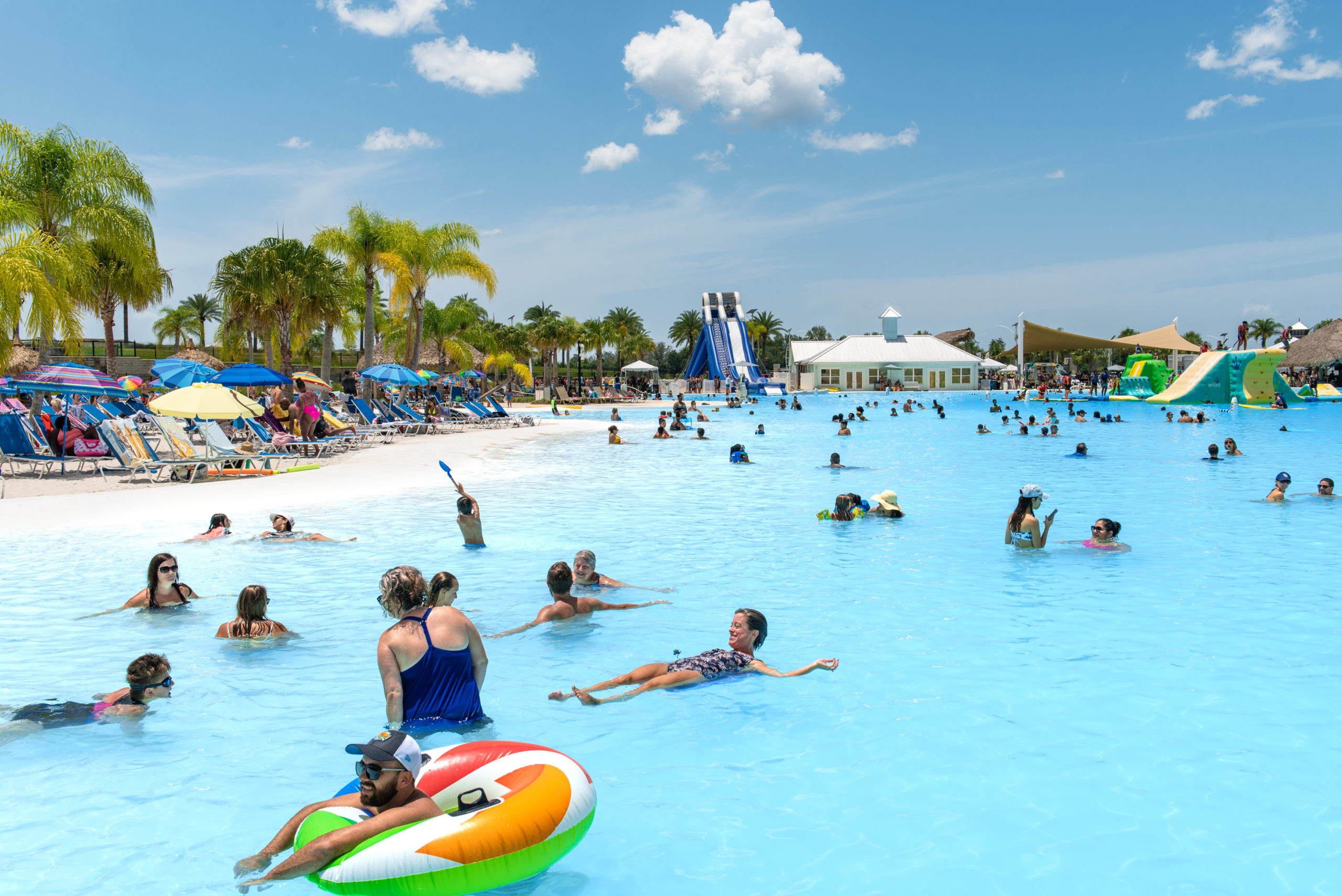 People swimming in Epperson Public Access Lagoon by Crystal Lagoons in Florida