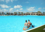 Two women on a kayak in a crystalline man-made lagoon powered by Crystal Lagoons technology