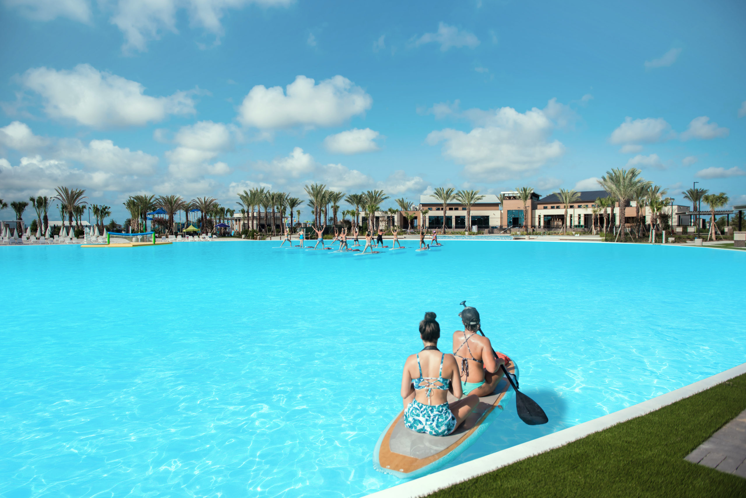 Two women on a kayak in a crystalline man-made lagoon powered by Crystal Lagoons technology