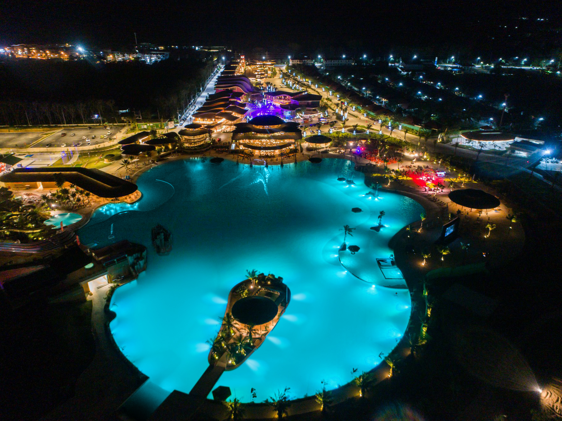 Aerial view of a crystalline lagoon surrounded lights